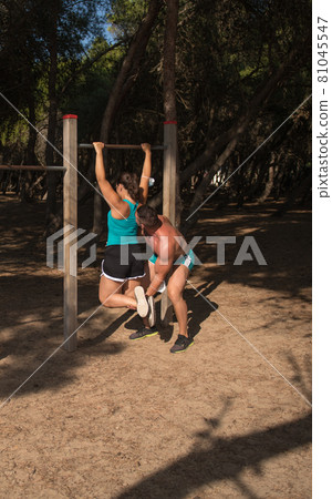 A middle age couple doing exercise outdoors in the park A middle age couple doing exercise outdoors in the park 81045547