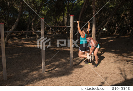 A middle age couple doing exercise outdoors in the park A middle age couple doing exercise outdoors in the park 81045548