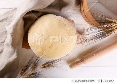 Raw homemande dough for bread or pizza with ears of wheat 81045562