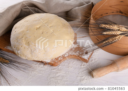 Raw homemande dough for bread or pizza with ears of wheat 81045563