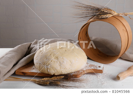 Raw homemande dough for bread or pizza with ears of wheat Raw homemande dough for bread or pizza with ears of wheat 81045566