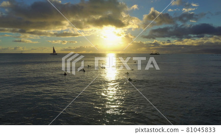 Amazing colors of tropical sunset. Sail boats silhouettes floating on ocean horizon. Oahu island, Hawaii summer vacation. 81045833