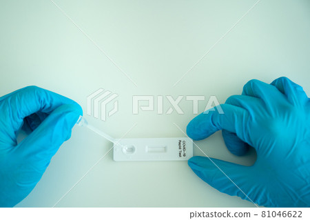Asian woman using COVID-19 antigen test. Asian woman using COVID-19 antigen test. 81046622