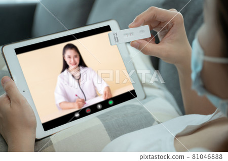 Asian woman making an online video call with doctor. Asian woman making an online video call with doctor. 81046888