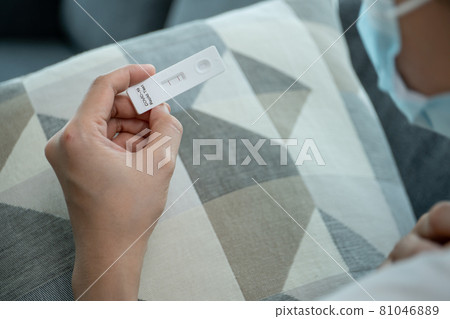 Woman using COVID-19 Antigen test. Woman using COVID-19 Antigen test. 81046889