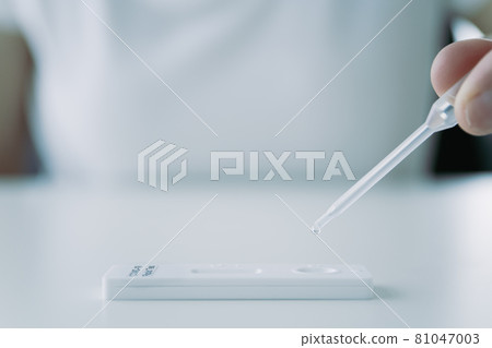Woman using COVID-19 antigen test. Woman using COVID-19 antigen test. 81047003