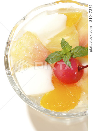A bird's-eye view of a fruit punch containing milk cans, pineapples, mangoes, white peaches, cherries, oranges, etc. on a white background 81047275