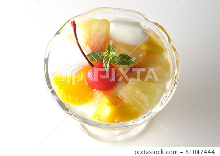 A bird's-eye view of a fruit punch containing milk cans, pineapples, mangoes, white peaches, cherries, oranges, etc. on a white background A bird's-eye view of a fruit punch containing milk cans, pineapples, mangoes, white peaches, cherries, oranges, etc. on a white background 81047444