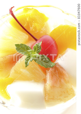 A bird's-eye view of a fruit punch containing milk cans, pineapples, mangoes, white peaches, cherries, oranges, etc. on a white background 81047600