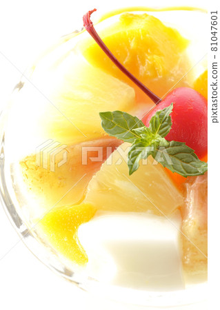 A bird's-eye view of a fruit punch containing milk cans, pineapples, mangoes, white peaches, cherries, oranges, etc. on a white background 81047601