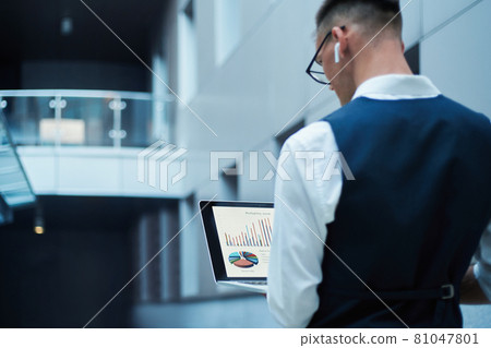 business man using a laptop to check financial data. business man using a laptop to check financial data. 81047801