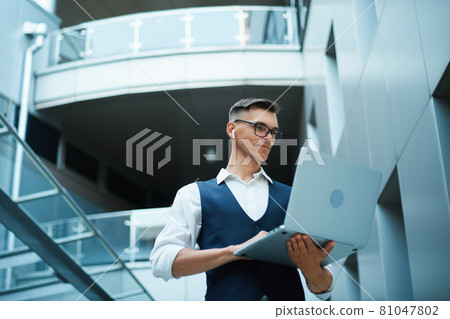 young man is working on a laptop. young man is working on a laptop. 81047802