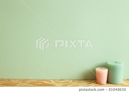 Color candles on wooden table. green wall background. home interior 81048630