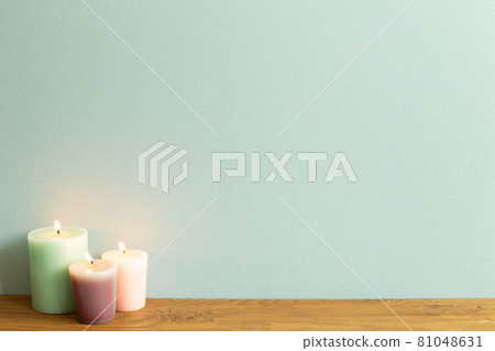 Color candles on wooden table. blue wall background. home interior Color candles on wooden table. blue wall background. home interior 81048631