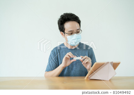 Asian man consult with doctor via online video conference. 81049492