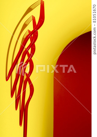 Abstract still life with red forks on a colored background Abstract still life with red forks on a colored background 81051670