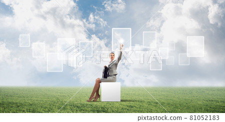 Attractive business lady or accountant outdoors on white box Attractive business lady or accountant outdoors on white box 81052183