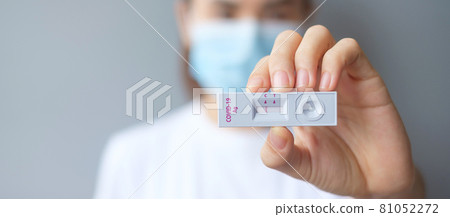 woman holding Rapid Antigen Test kit with Negative result during swab COVID-19 testing. Coronavirus Self nasal or Home test, Lockdown and Home Isolation concept 81052272