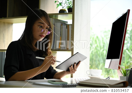Businesswoman working with computer and using digital tablet. Businesswoman working with computer and using digital tablet. 81053457