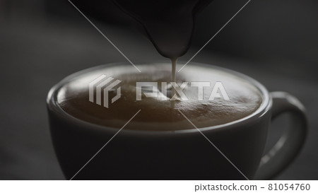 Pour streamed milk into white cup to make cappuccino Pour streamed milk into white cup to make cappuccino 81054760