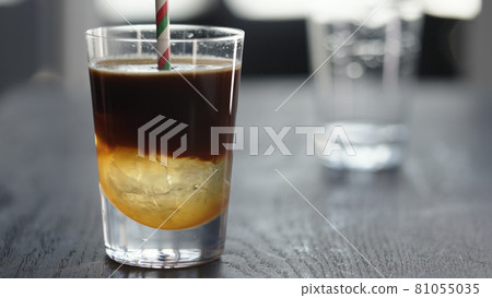 Making espresso tonic in tumbler with ice ball Making espresso tonic in tumbler with ice ball 81055035