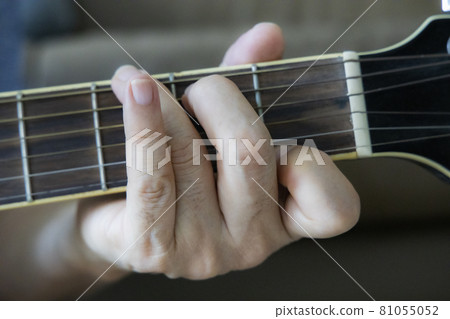 Hand holding guitar chords Hand holding guitar chords 81055052
