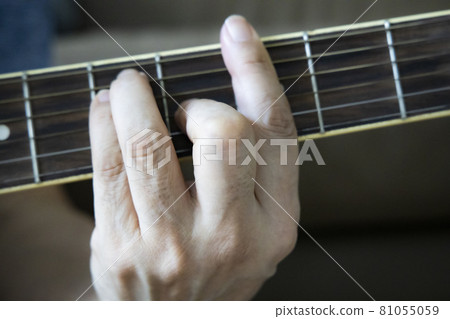 Hand holding guitar chords Hand holding guitar chords 81055059