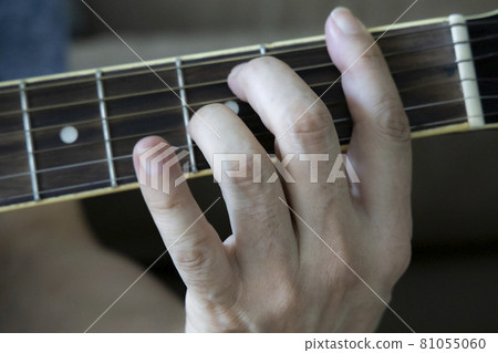 Hand holding guitar chords Hand holding guitar chords 81055060