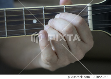Hand holding guitar chords Hand holding guitar chords 81055068