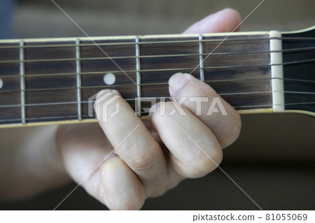 Hand holding guitar chords Hand holding guitar chords 81055069