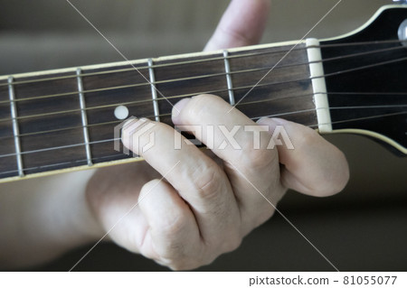 Hand holding guitar chords Hand holding guitar chords 81055077