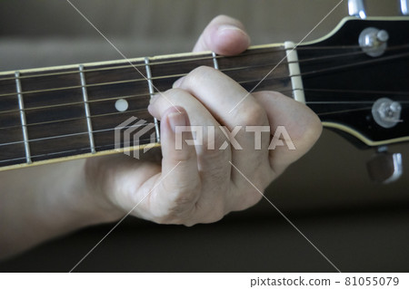 Hand holding guitar chords Hand holding guitar chords 81055079