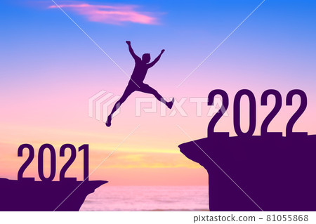Silhouette man jumping between cliff with number 2021 to 2022 at tropical sunset beach. Freedom challenge and travel adventure holiday concept. 81055868