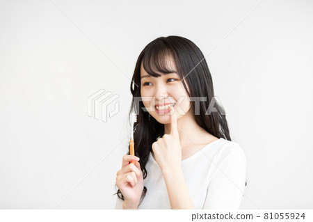 Teenage woman doing dental care Teenage woman doing dental care 81055924