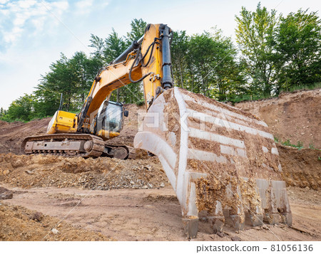 Track type loader is mining stones in opencast mining quarry. 81056136