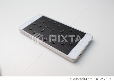 Mobile phone with drops on oleophobic screen. 81057887