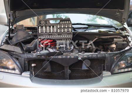 Car with open hood, set of keys and wires for ignition on engine. 81057970