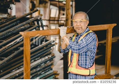 Healthy strong elder old man worker hard working in construction site with protection safety. 81059236