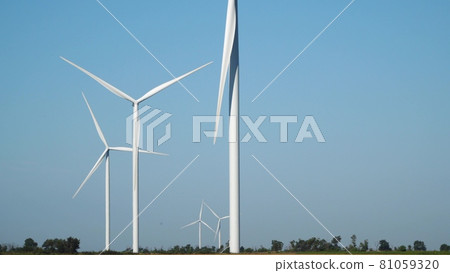 Wind farm on a background of blue sky among agricultural fields 81059320