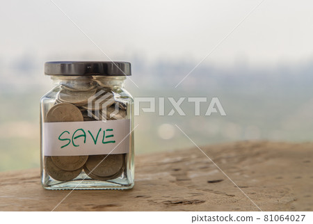 The pile of coins in glass bottle on sky background for concept for growth and saving money. 81064027