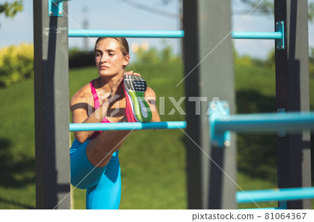 Young slim sportive caucasian woman working out, doing fitness, yoga in the park or on city street. Young slim sportive caucasian woman working out, doing fitness, yoga in the park or on city street. 81064367