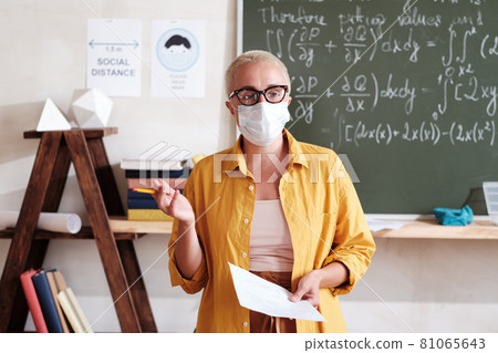 Teacher in mask standing in the classroom Teacher in mask standing in the classroom 81065643