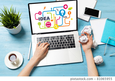 Developer sitting at desk and working with laptop 81065955