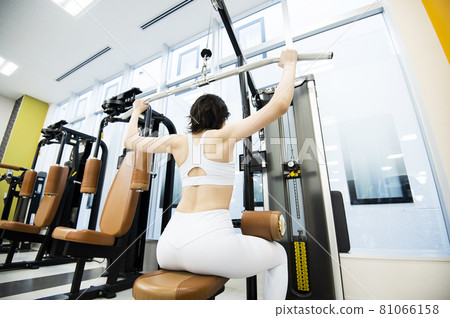 Female training sports gym lat pull-down rear view 81066158