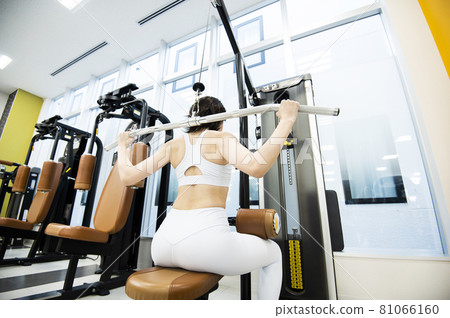 Female training sports gym lat pull-down rear view 81066160