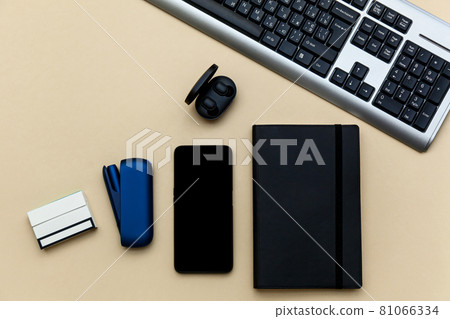 Iqos electronic blue cigarette on a beige background. Iqos electronic blue cigarette on a beige background. 81066334
