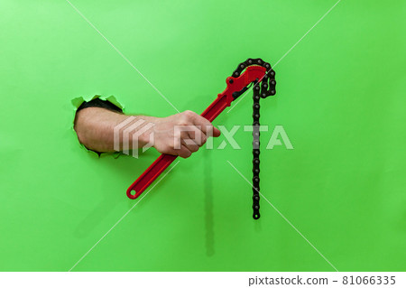 hand holds an adjustable key hand holds an adjustable key 81066335