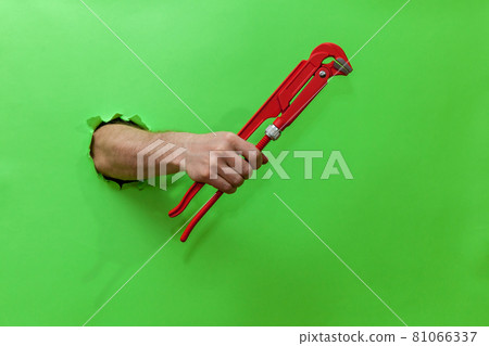 hand holds an adjustable key hand holds an adjustable key 81066337