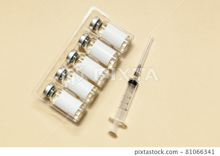 Syringe with a vaccine on a beige background Syringe with a vaccine on a beige background 81066341