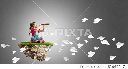 Concept of careless happy childhood with girl looking in spyglass Concept of careless happy childhood with girl looking in spyglass 81066647